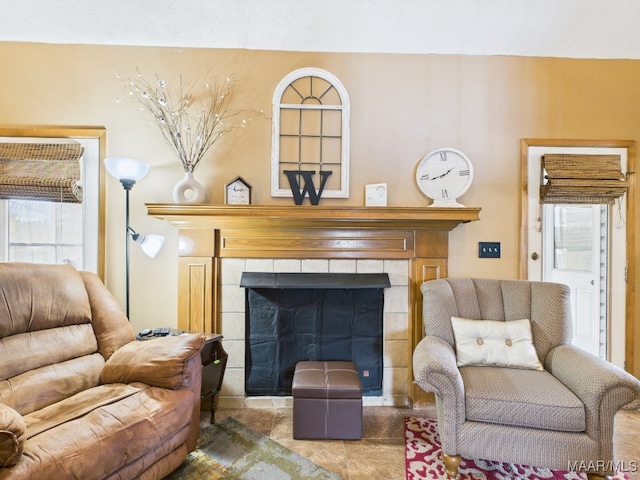 living area with a tile fireplace