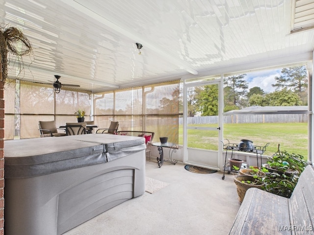 sunroom / solarium featuring a ceiling fan