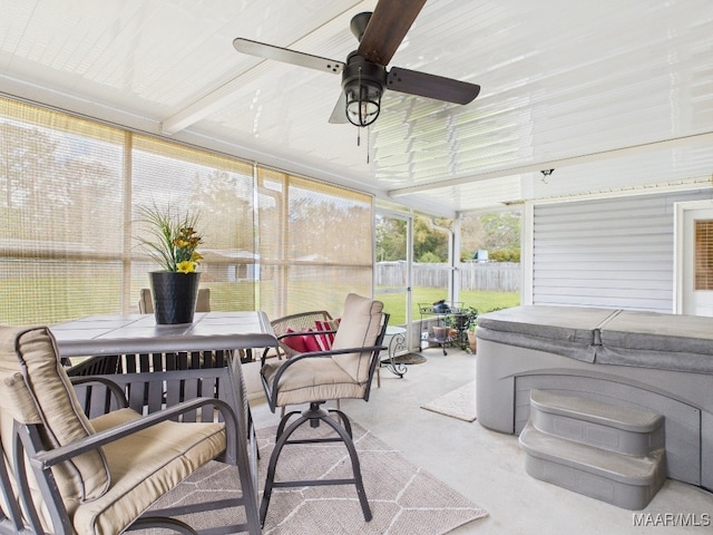 sunroom featuring a ceiling fan