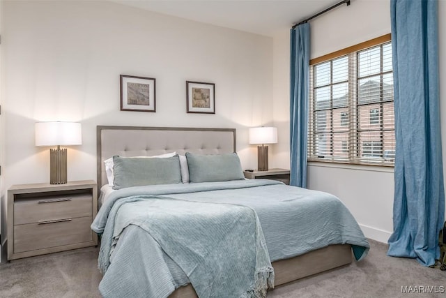 bedroom with carpet flooring and baseboards