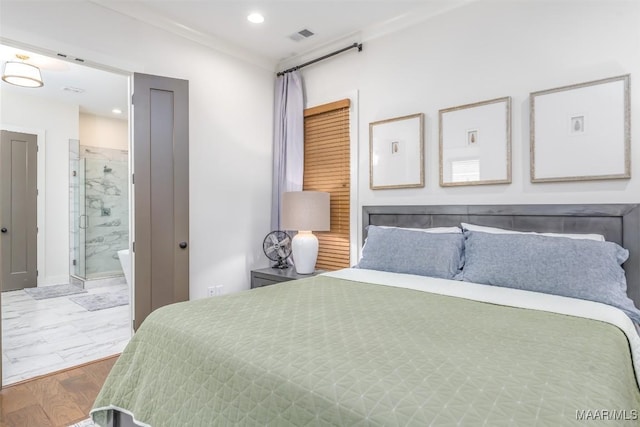 bedroom with recessed lighting, wood finished floors, visible vents, and connected bathroom