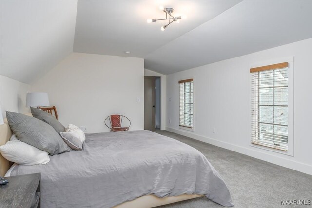 bedroom featuring vaulted ceiling, carpet, and baseboards