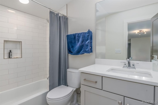 full bathroom featuring shower / bath combo with shower curtain, toilet, and vanity