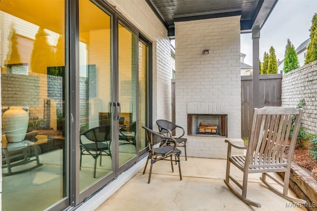 exterior space with a patio and an outdoor brick fireplace