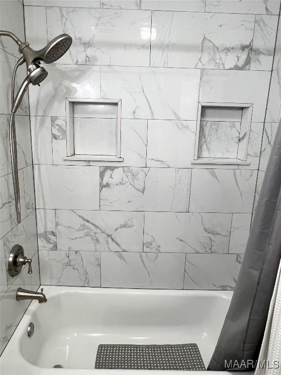 full bathroom with shower / bath combo