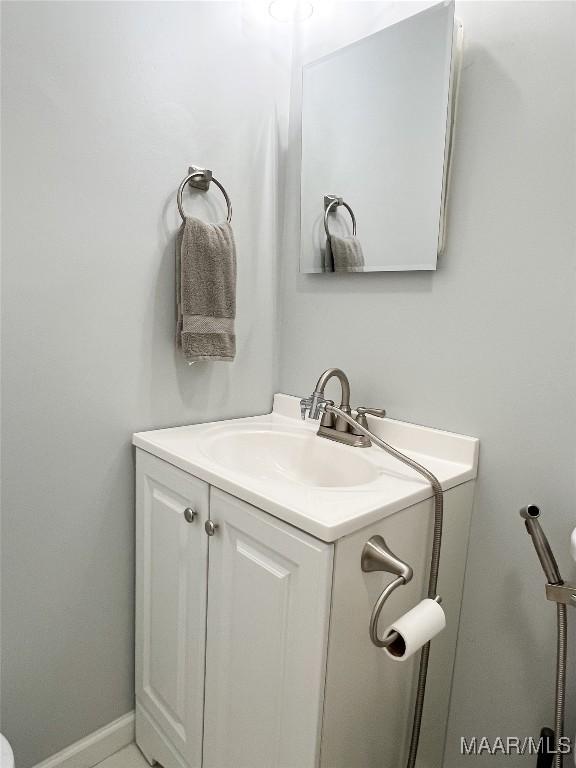 bathroom with baseboards and vanity