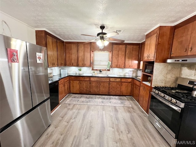 kitchen with under cabinet range hood, stainless steel appliances, brown cabinetry, and light wood finished floors