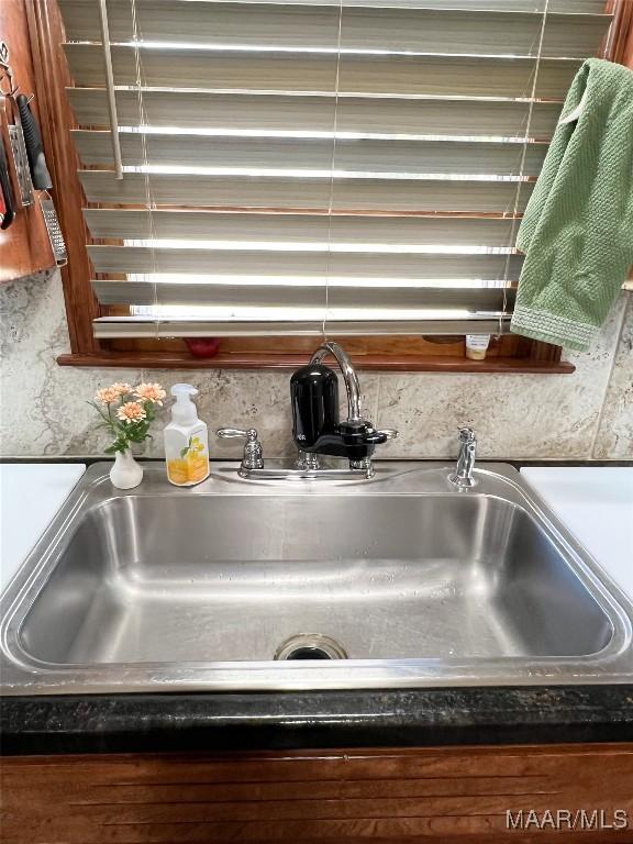 room details featuring dark countertops and a sink