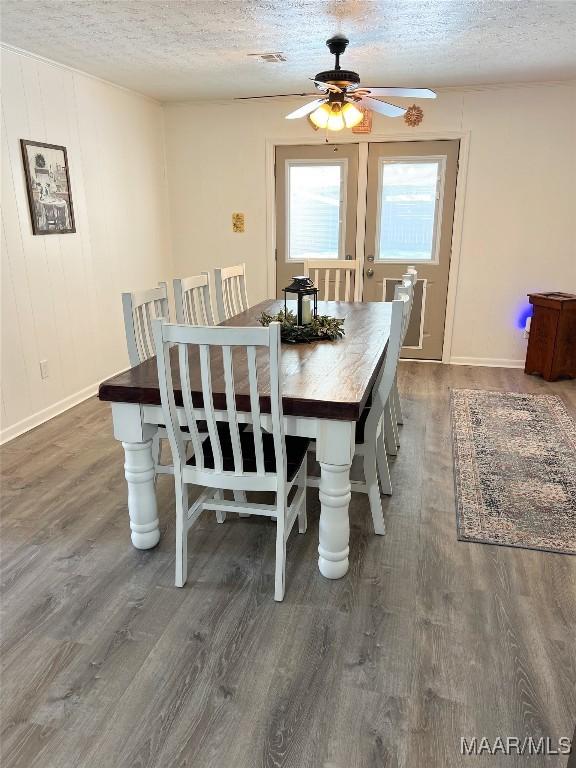 dining room featuring dark wood-style floors, a textured ceiling, and a ceiling fan