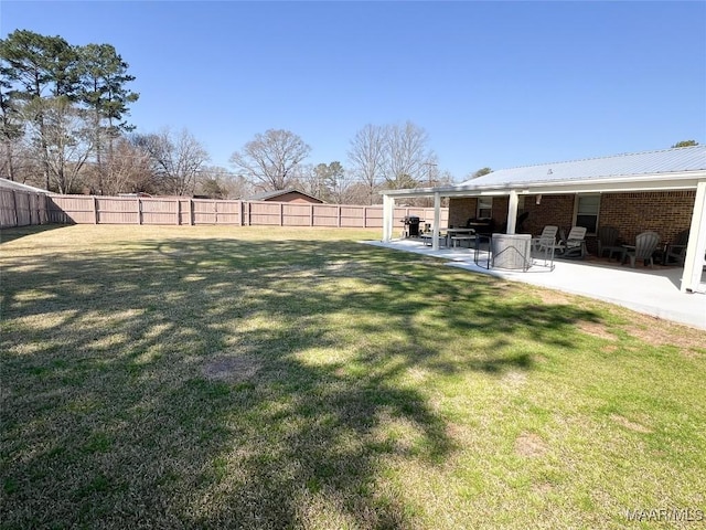 view of yard featuring a patio and a fenced backyard