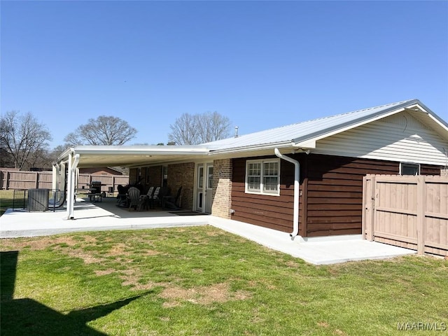 back of house with a patio, a yard, and fence