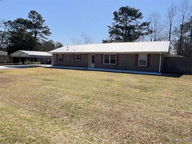 ranch-style home with brick siding, a carport, a front yard, and fence