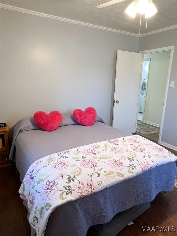 bedroom featuring wood finished floors, ceiling fan, crown molding, and baseboards
