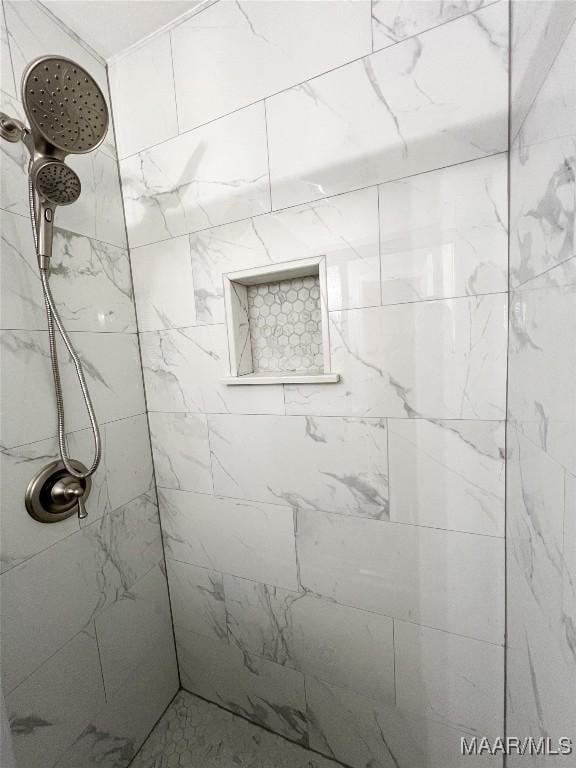 bathroom with tiled shower