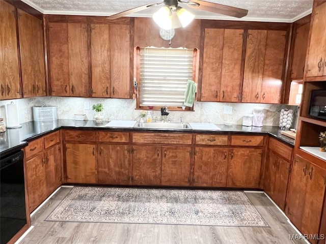 kitchen featuring brown cabinetry, black appliances, ceiling fan, and a sink