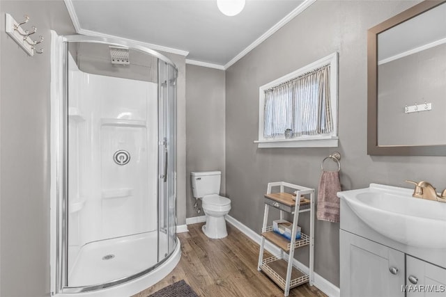 full bath featuring vanity, wood finished floors, a shower stall, crown molding, and toilet