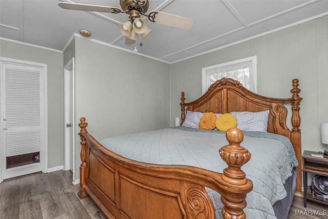 bedroom with ceiling fan, dark wood finished floors, and ornamental molding