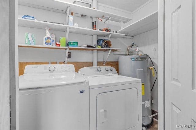 clothes washing area with washing machine and clothes dryer, laundry area, and electric water heater