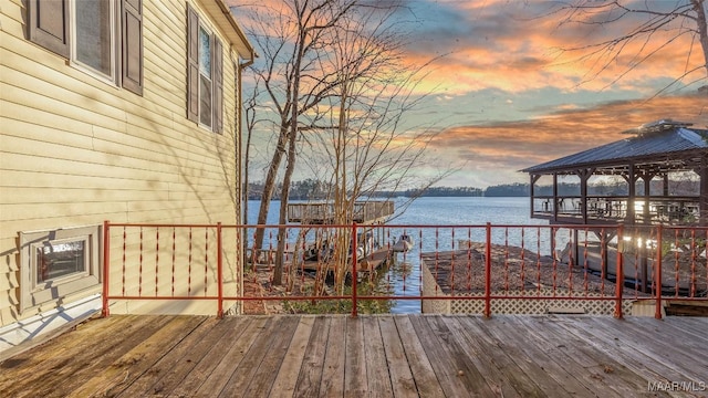 deck with a gazebo and a water view