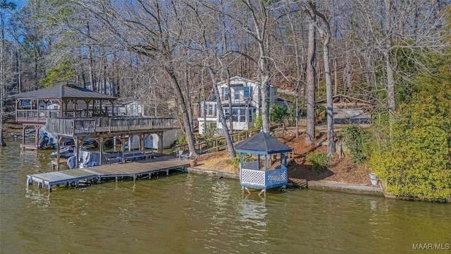 view of dock featuring a gazebo and a water view