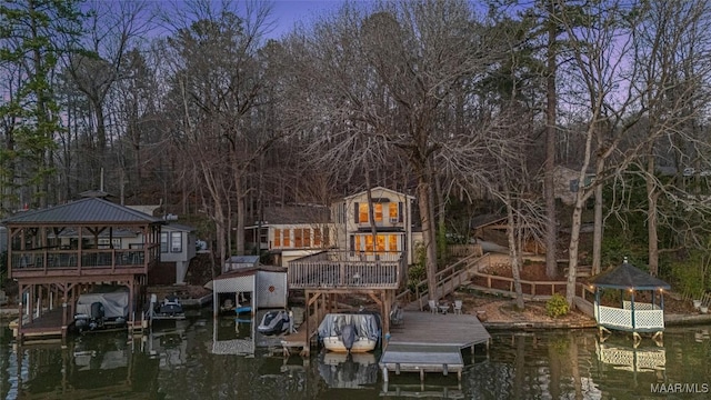 dock area featuring a gazebo, boat lift, and a water view