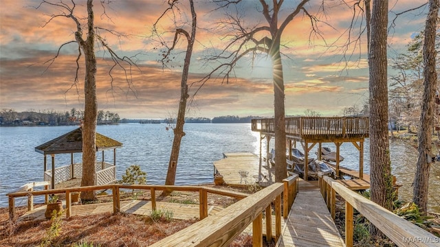 dock area with boat lift and a water view