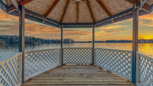 wooden terrace with a gazebo and a water view