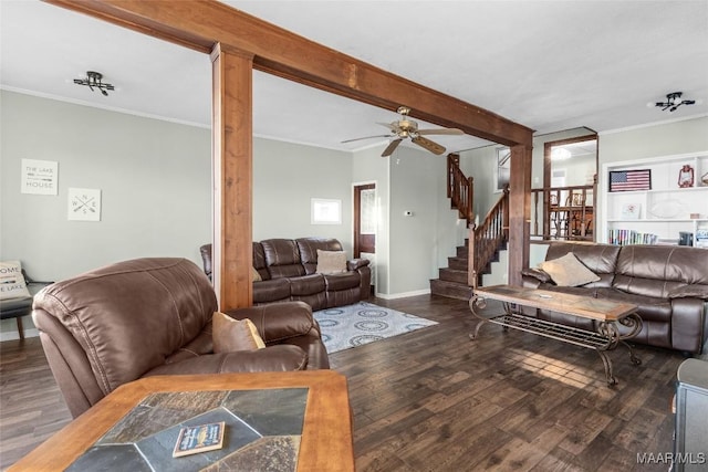 living area featuring stairway, ornamental molding, beam ceiling, wood finished floors, and a ceiling fan