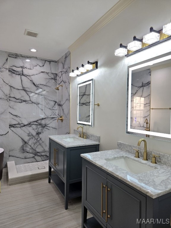 bathroom featuring a sink, a marble finish shower, and crown molding