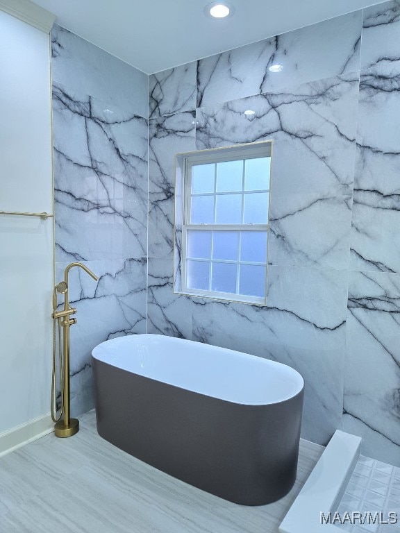 full bath featuring recessed lighting and a soaking tub