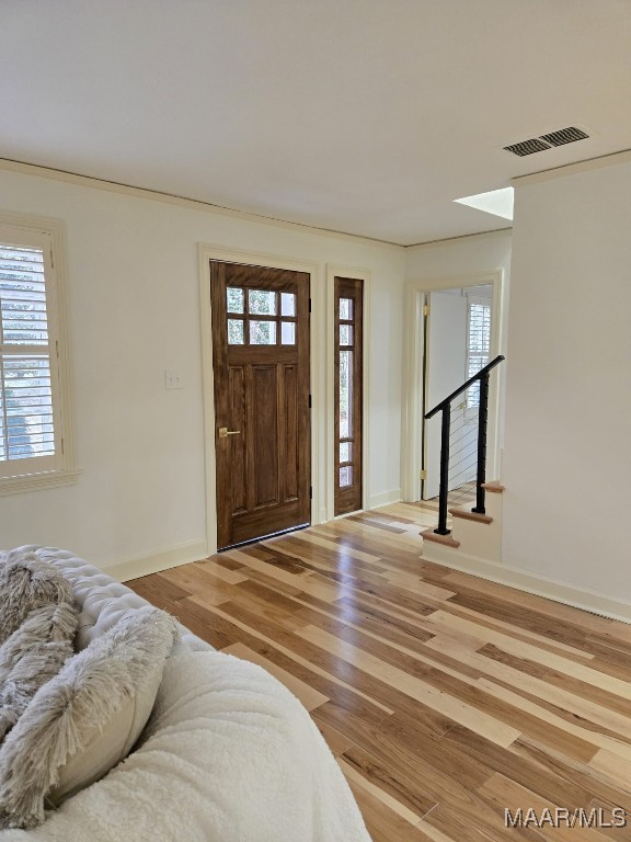 entrance foyer with visible vents, baseboards, and wood finished floors