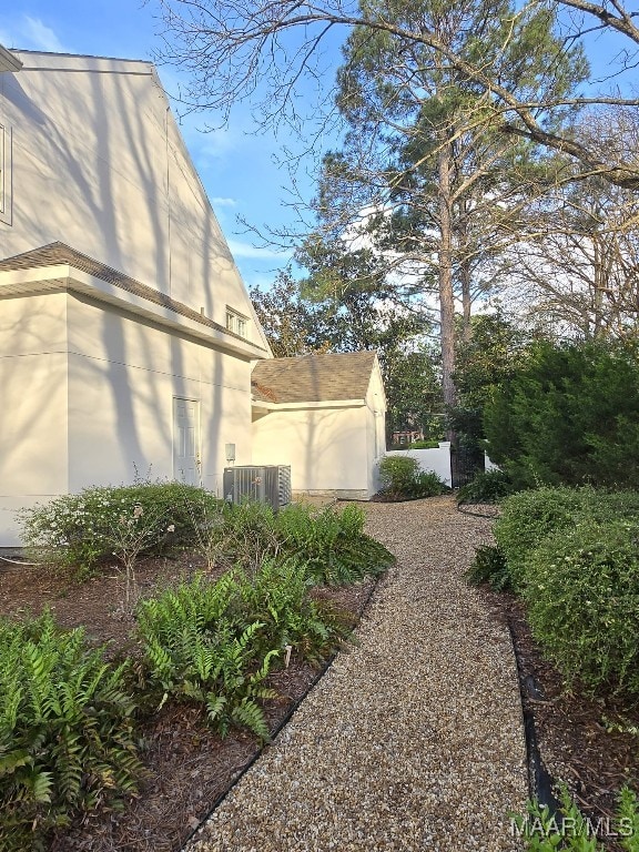 view of property exterior featuring stucco siding and central AC