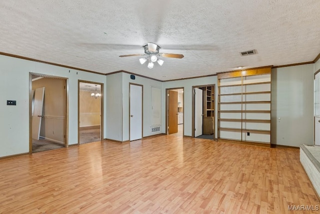 interior space featuring visible vents, ceiling fan with notable chandelier, a textured ceiling, and light wood-style floors