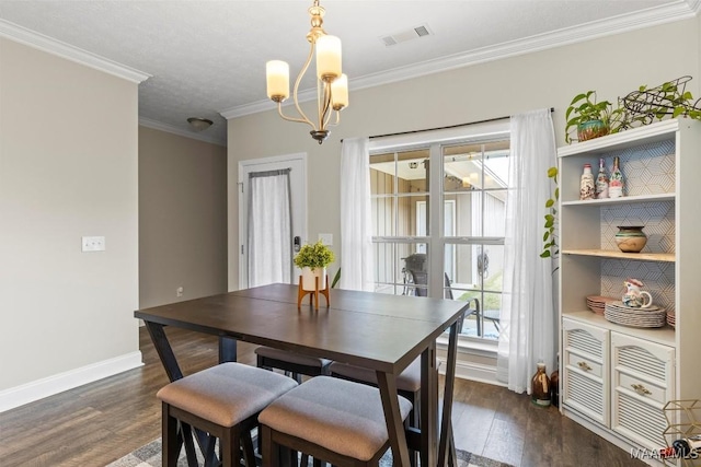 dining area featuring baseboards, a notable chandelier, dark wood finished floors, and crown molding