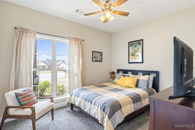 bedroom featuring carpet flooring, ceiling fan, and visible vents