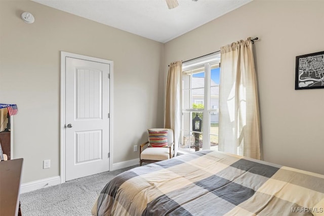 carpeted bedroom featuring a ceiling fan and baseboards