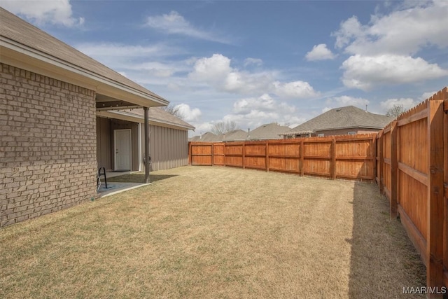 view of yard with a fenced backyard and a patio area