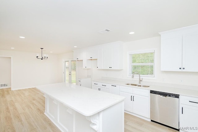 kitchen with a kitchen island, recessed lighting, a sink, light wood-style floors, and stainless steel dishwasher