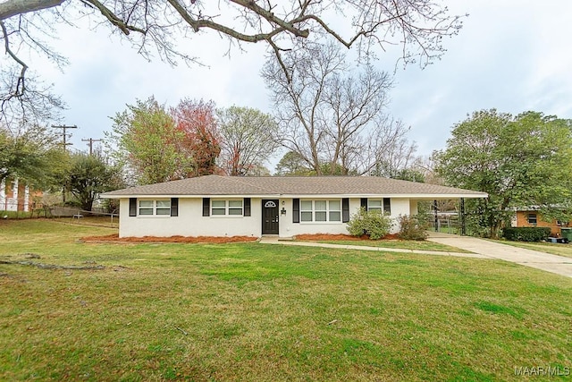 single story home with an attached carport, a front yard, concrete driveway, and stucco siding