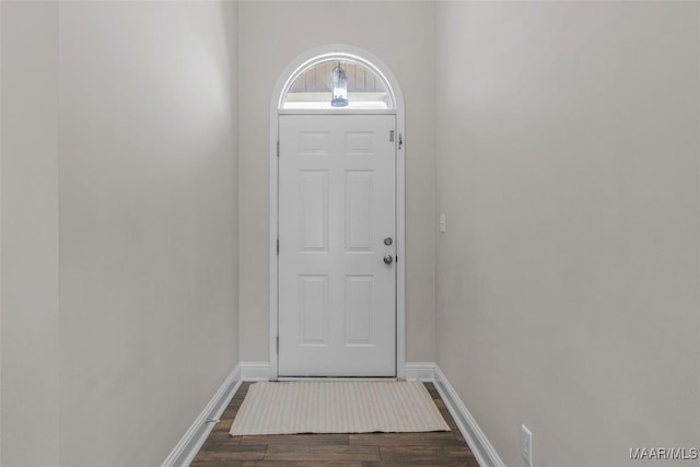 doorway to outside featuring dark wood-style floors and baseboards