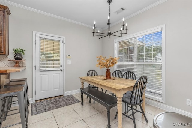 dining room with visible vents, ornamental molding, an inviting chandelier, light tile patterned floors, and baseboards