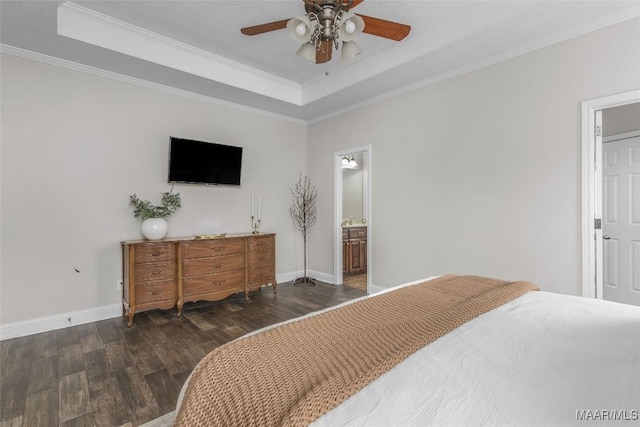 bedroom featuring a raised ceiling, crown molding, wood finished floors, and baseboards