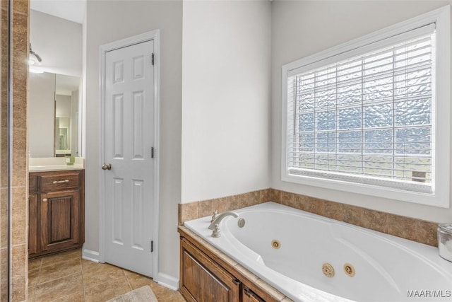 full bath featuring tile patterned floors, vanity, and a whirlpool tub