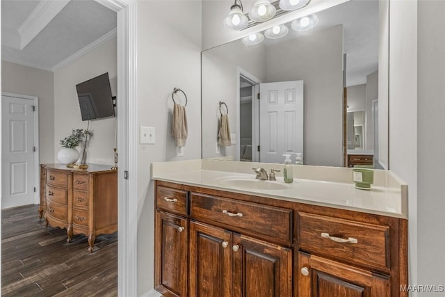 bathroom featuring vanity, crown molding, and wood finished floors