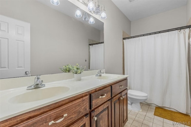 bathroom featuring a sink, toilet, double vanity, and tile patterned floors