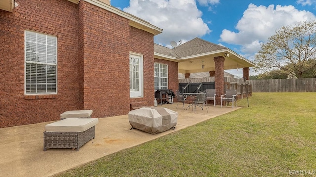 view of patio with grilling area and fence