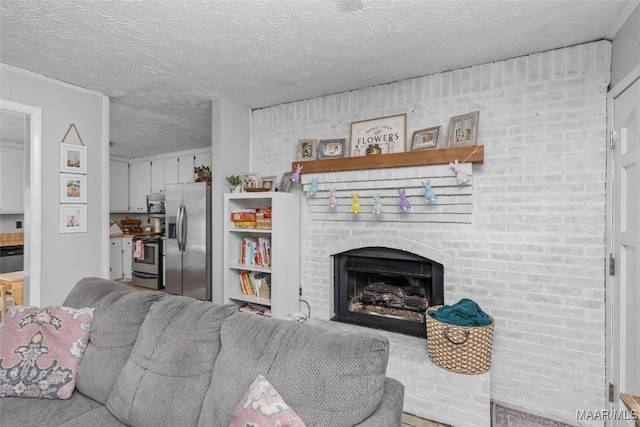 living area with a brick fireplace and a textured ceiling