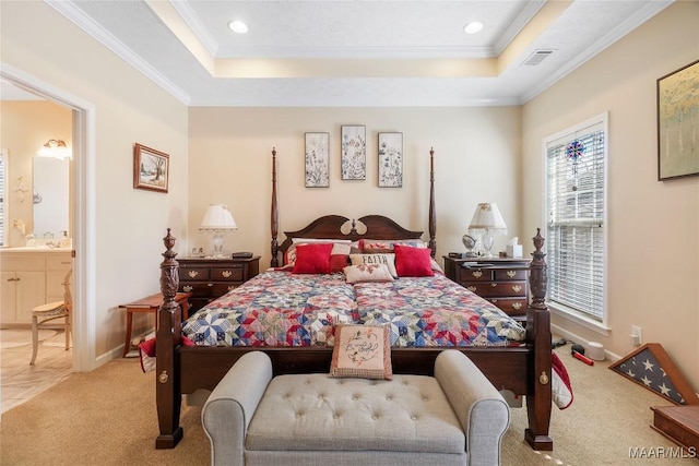 bedroom featuring carpet, visible vents, ornamental molding, a raised ceiling, and connected bathroom