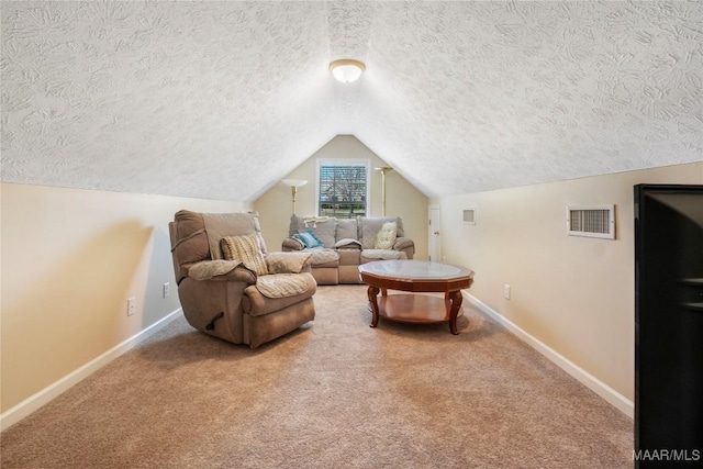 interior space featuring visible vents, baseboards, carpet, vaulted ceiling, and a textured ceiling