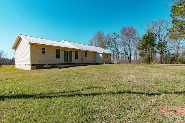 25882 Troy Hwy, Grady, AL 36036 - back of property with crawl space, a lawn, and metal roof
